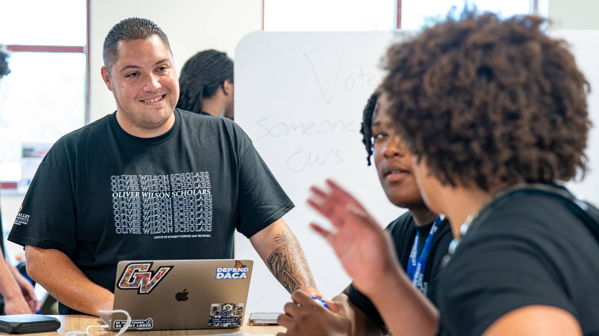 Adrian Hall provides success coaching to two Oliver Wilson Scholar students.
